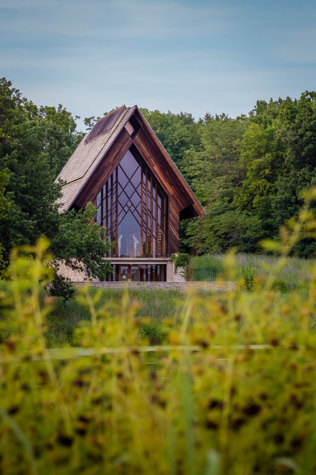 Marjorie Powell Allen Chapel glass and wood A-frame designed by E Fay Jones through wildflower meadow at Powell Gardens near Kansas City